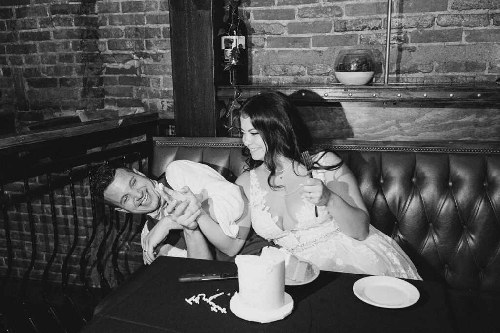 Bride and groom cutting wedding cake