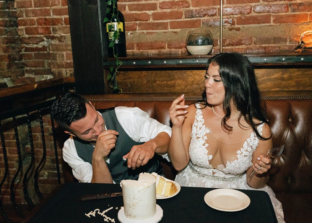 Bride and groom cutting wedding cake