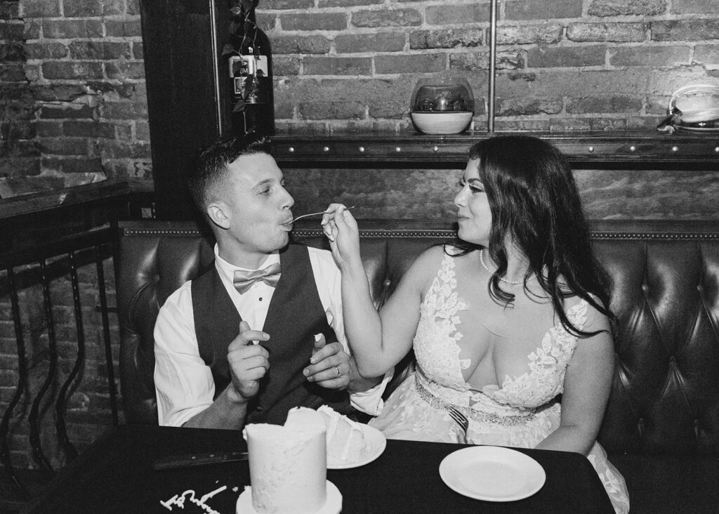 Bride and groom cutting wedding cake