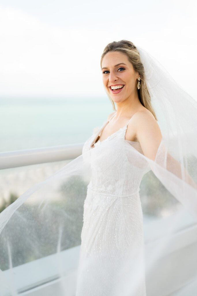 Bride standing on hotel patio with beach views