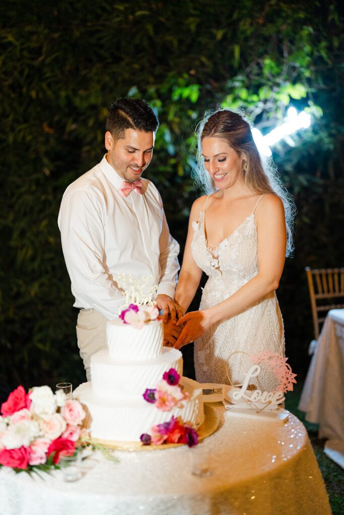 Bride and groom cutting wedding cake