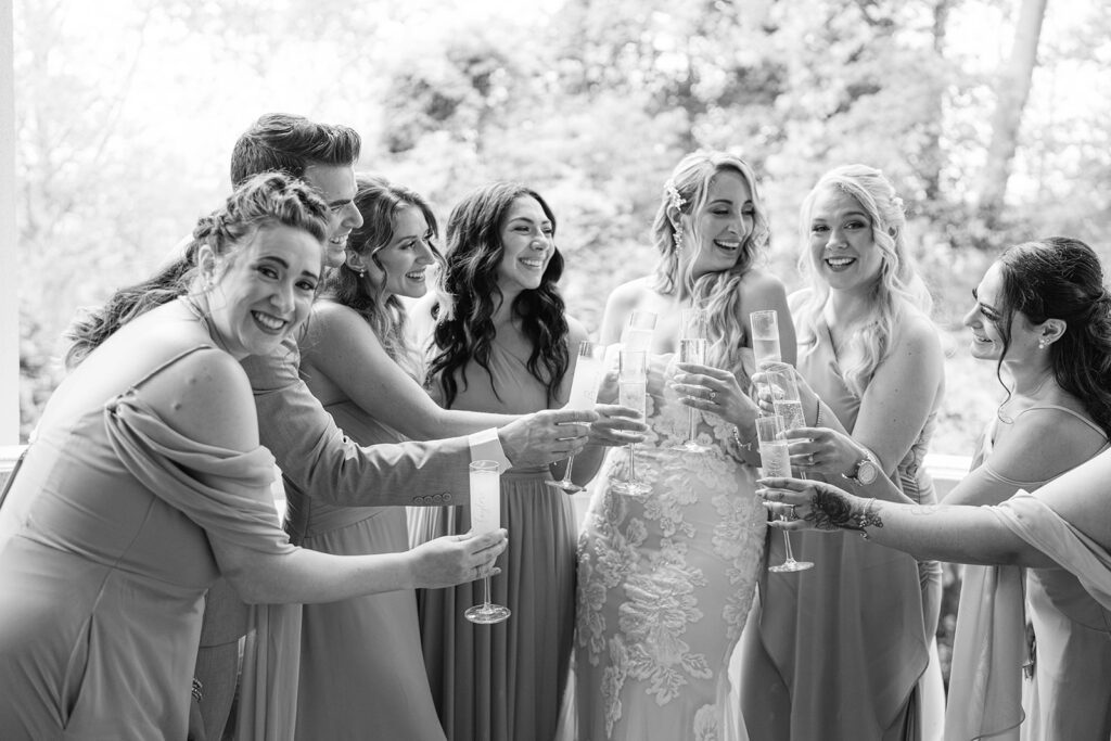 Bride and bridesmaids toasting captured by luxury wedding photographer - Jennifer Sofia Studios